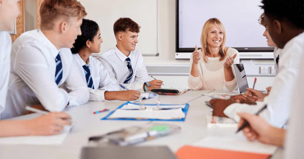 Teacher with students at table